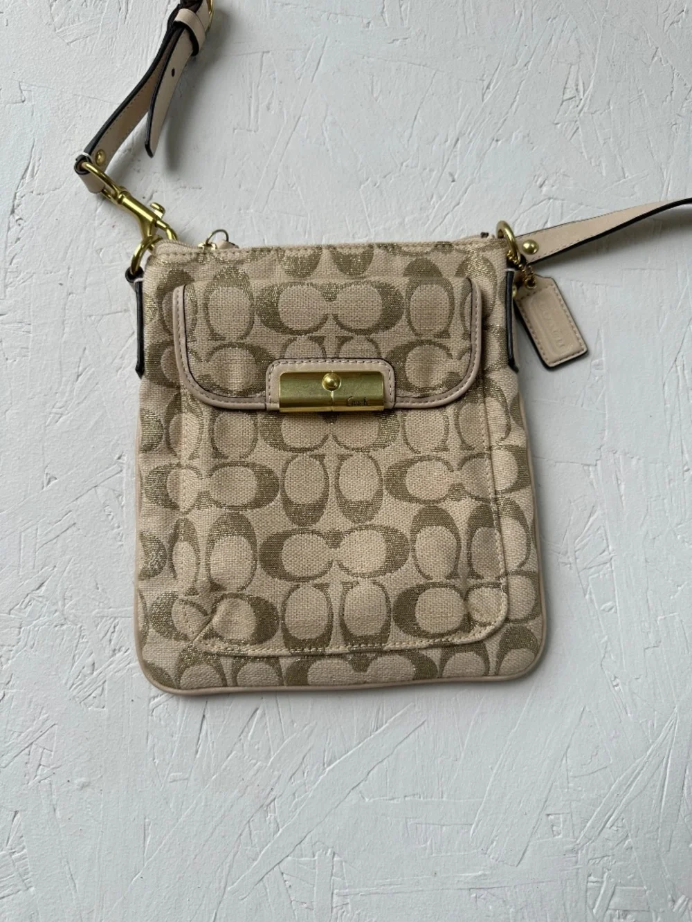 Coach Kristin Signature Crossbody Swing Bag in a metallic gold and beige fabric